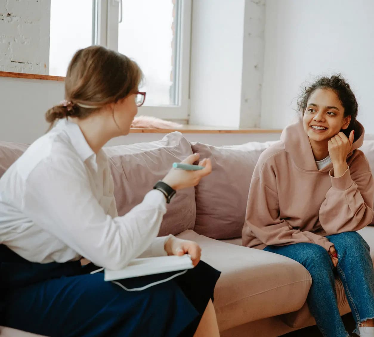 A therapist listening to a person during a consultation.